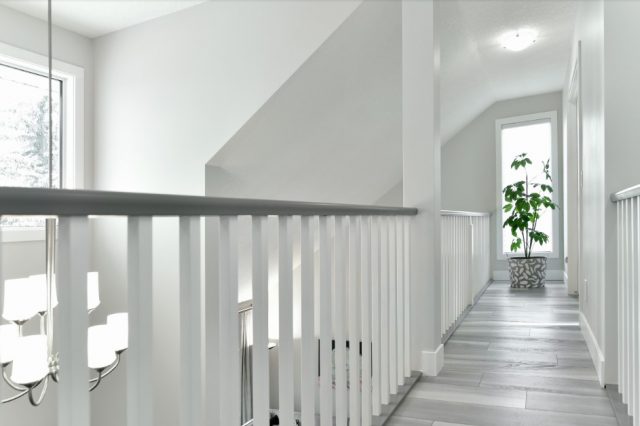 Renovated catwalk with a white railing and new grey plank flooring