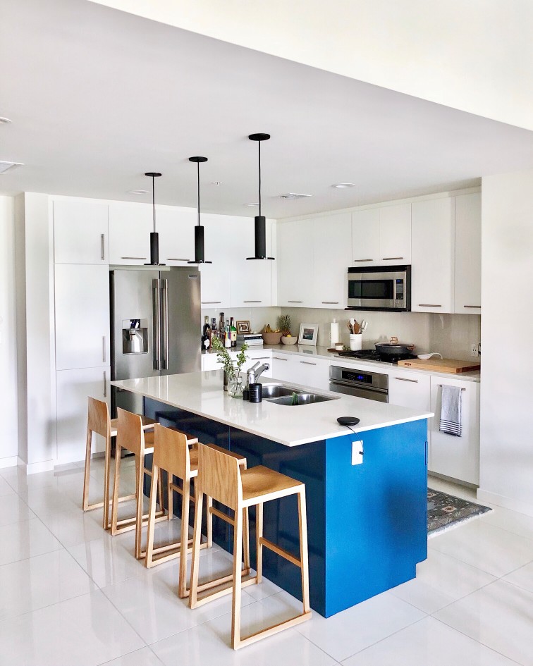 kitchen with white cupboards and blue island