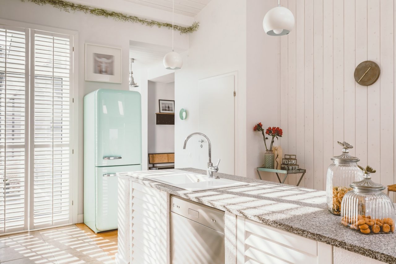 white kitchen with a light blue retro style fridge